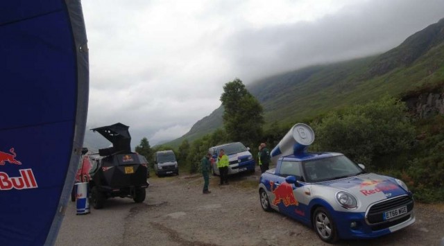 Red bull Vehicles at a car park in the mountains.