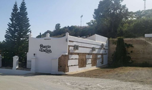 White building among trees.